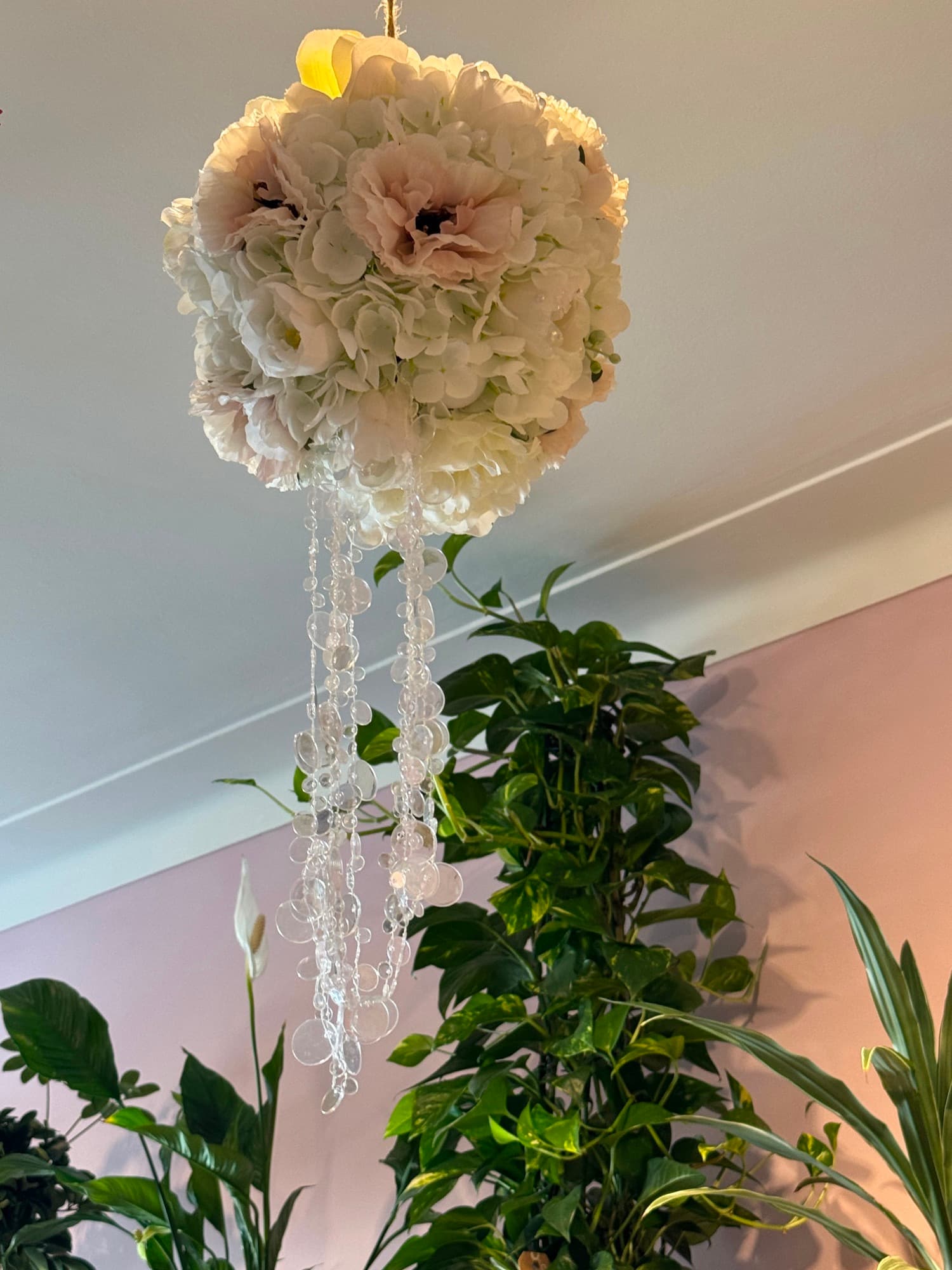 A hanging decoration of dried white flowers with beads