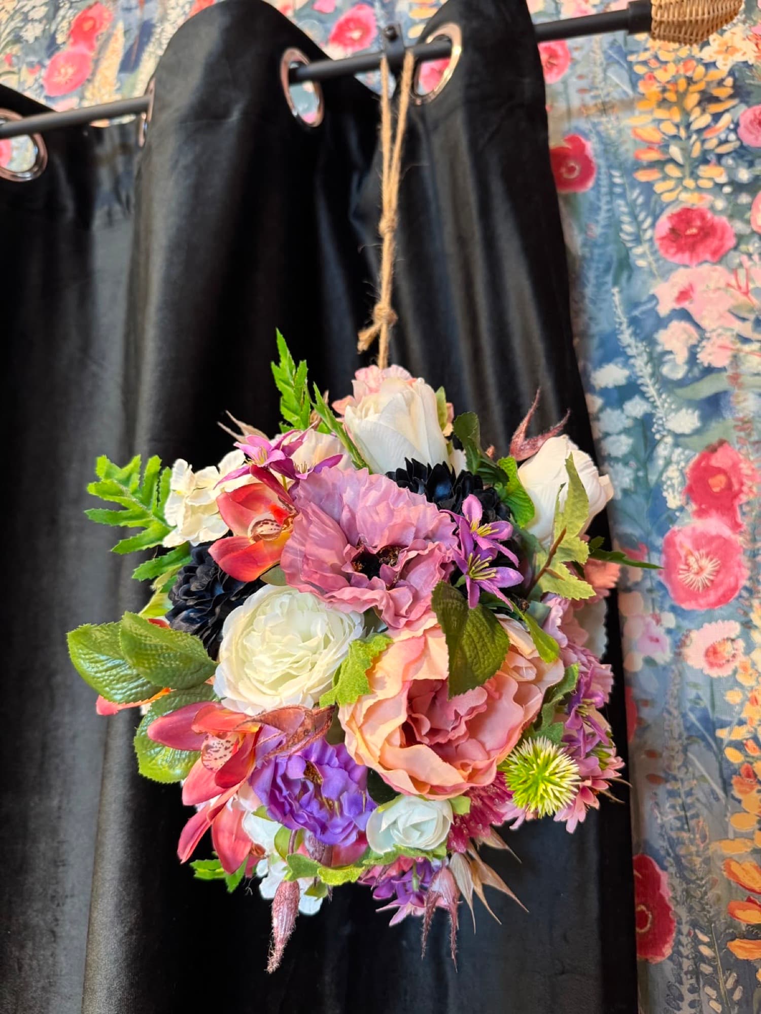 A hanging dried-flower wreath on a stand