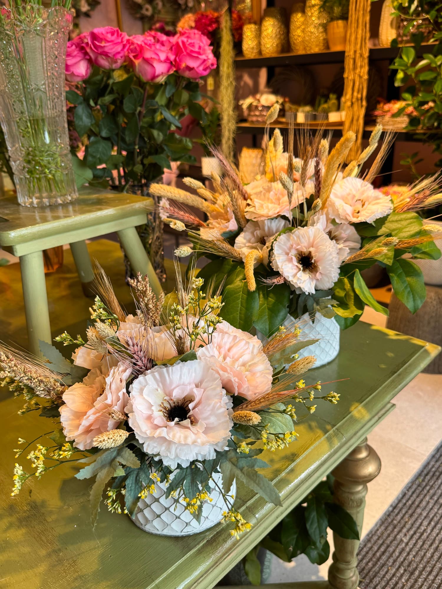 Small arrangements and wreaths on a table