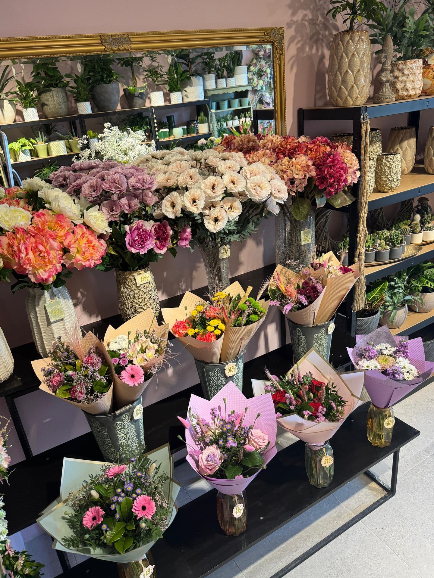 A bench full of fresh wrapped bouquets in the shop