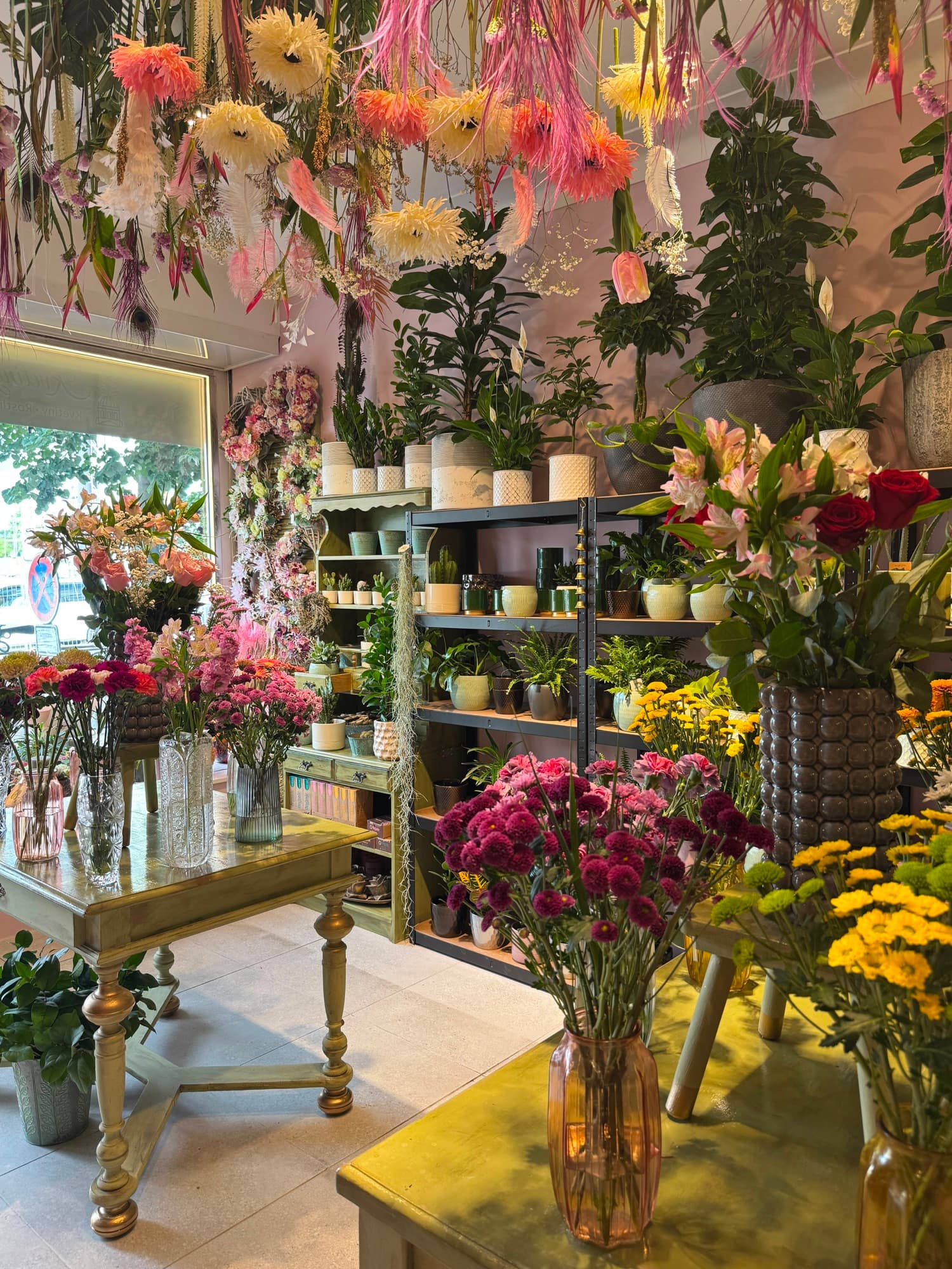 A painted dresser with fresh flowers in the shop